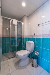 a bathroom with a toilet and a glass shower at Castello Hotel & Aparts in Kemer
