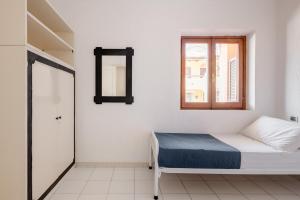 A bed or beds in a room at Casa Lu Maccu - Sea View Apartment