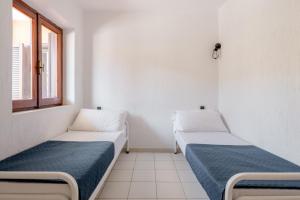 A bed or beds in a room at Casa Lu Maccu - Sea View Apartment