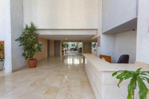 a large lobby with plants in a building at Apartments Tropic Mar, LEVANTE beach, Benidorm in Benidorm