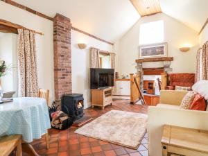 a living room with a fireplace and a stove at Slade Tops in Ashbourne