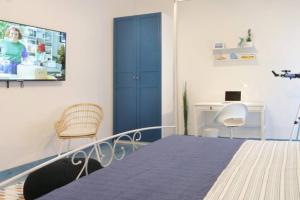 a bedroom with a bed and a chair and a desk at Il Nido di Raito in Vietri sul Mare