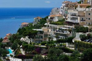 a group of buildings on a hill next to the ocean at Il Nido di Raito in Vietri sul Mare