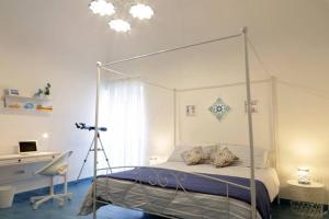 a bedroom with a canopy bed and a desk at Il Nido di Raito in Vietri sul Mare