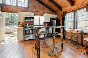 a kitchen with wooden floors and a wooden ceiling at Idlewild in Sautee Nacoochee