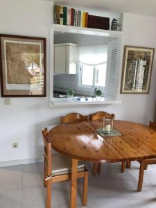 a wooden table and chairs in a room at Beach Apartment Minerva in Port d'Alcudia
