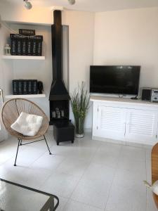 a living room with a fireplace and a flat screen tv at Beach Apartment Minerva in Port d'Alcudia