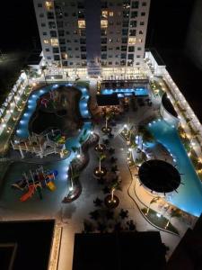 a large swimming pool in a city at night at Salinas Exclusive Resort - 402-II in Salinópolis