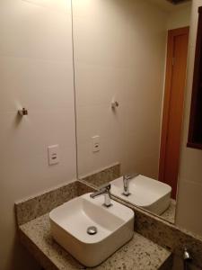 a bathroom with a sink and a mirror at Salinas Exclusive Resort - 402-II in Salinópolis +2 photos