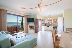 a living room and kitchen with a couch and a table at Nikolas Guest House Villa in Nikiana