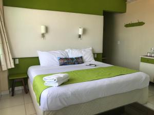 a bedroom with a large bed with towels on it at Casa Mia in Puerto Escondido