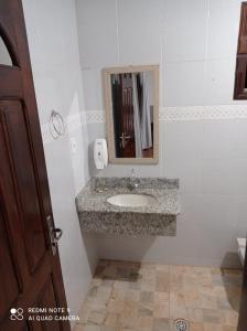 a bathroom with a sink and a mirror at RECANTO CANTAGALO Hotel in Cantagalo +102 photos