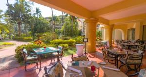 a restaurant with tables and chairs on a patio at Velas Vallarta Condo in Puerto Vallarta