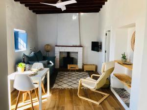 a living room with a table and chairs and a fireplace at Damajuana in Níjar