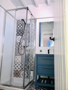 a shower in a bathroom with a blue dresser at Damajuana in Níjar +32 photos