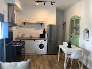 a kitchen with a refrigerator and a table with chairs at Damajuana ll in Níjar