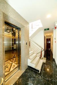 a lobby of a building with a glass elevator at Mira Eco Hotel Quy Nhơn in Quy Nhon