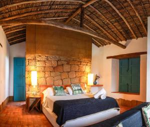 
a bedroom with a bed, a chair, and a window at Serrania del Viento in Barichara
