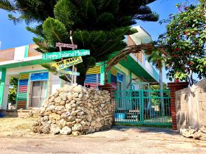 a building with a palm tree in front of it at Happy Island Miyako in Miyako-jima