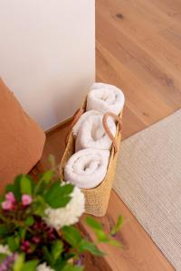 a basket of towels sitting on a wooden floor at Winzer Appartements Kogler in Leutschach +44 photos