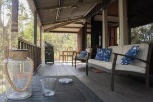 a porch of a house with a table and chairs at Barrabup Sanctuary BirdHide in Nannup