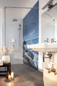 a bathroom with a sink and a shower at Meerhotel Großenbrode in Großenbrode