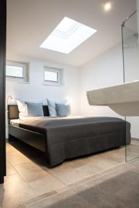 a bedroom with a bed with a skylight at Meerhotel Großenbrode in Großenbrode