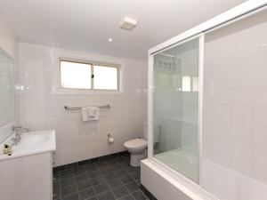 a bathroom with a toilet and a sink and a shower at Torino 2 14 Nettin Circuit in Jindabyne +9 photos