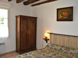 a bedroom with a bed and a wooden cabinet at Gîte Azay-sur-Cher, 6 pièces, 11 personnes - FR-1-381-359 in Azay-sur-Cher