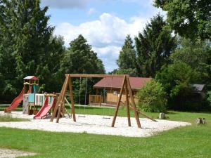 a playground with a swing set in a park at Gîte Radon, 2 pièces, 3 personnes - FR-1-497-130 in Radon