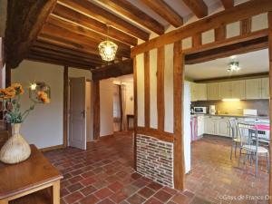 a kitchen and dining room with a vase of flowers at Gîte Crouttes, 4 pièces, 6 personnes - FR-1-497-19 in Crouttes