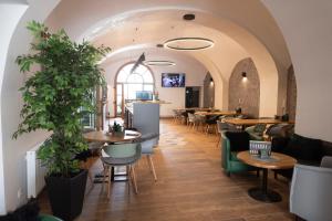 a restaurant with tables and chairs in a room at Rezidence Černý medvěd in Znojmo