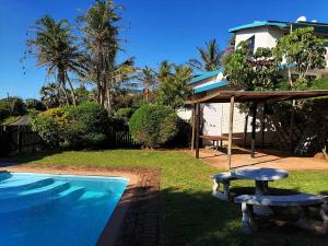 a house with a swimming pool with a bench next to it at Boathouse Bed & Biscuit - Lower Deck in Margate