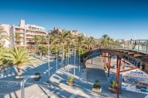 a view of a city with palm trees and a bridge at Sa Nacra in Alcudia