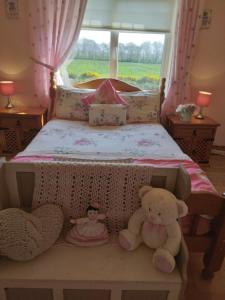 a bedroom with a bed with two teddy bears on it at Wild Atlantic Stays in Castlemaine