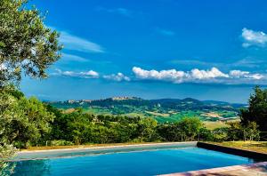 a swimming pool with a view of the mountains at Relais La Chiusa Boutique Inn in Montefollonico