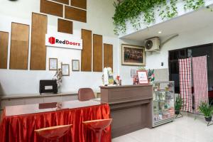 SumenepにあるRedDoorz @ Hotel Surabaya Sumenepの赤い部屋の看板が壁に貼られたレストラン