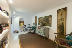 a living room with a desk and a bike in it at Halo - Typical Spanish Downtown House Close To The Sea in Marbella