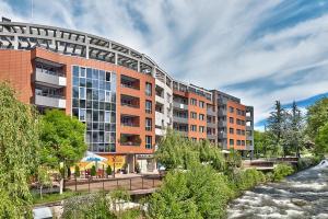 a rendering of a building next to a river at Hotel Elit in Sandanski