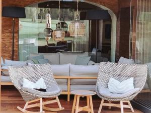 two chairs sitting on a patio with a couch at Gut Weissenhof in Radstadt