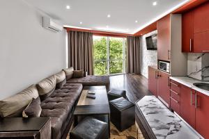 a living room with a couch and a table at Hotel Elit in Sandanski
