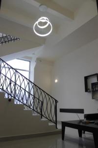 a staircase in a living room with a light fixture at Sevan Hotel in Sevan