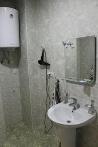 a bathroom with a sink and a mirror at Sevan Hotel in Sevan