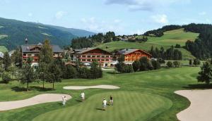 a group of people playing golf on a golf course at Gut Weissenhof in Radstadt