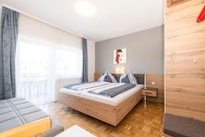 Postel nebo postele na pokoji v ubytování Gästehaus Genf