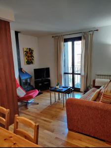 a living room with a couch and a table at CHECK-IN CASAS Labert in Benasque