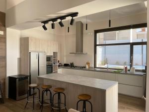 a kitchen with a counter and stools in it at Casa Juliana in Herencia