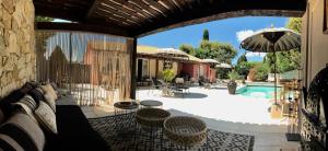 a patio with a couch and a swimming pool at VILLA MATHIS in Mouans-Sartoux