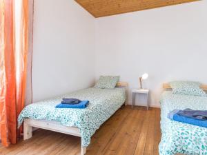 a bedroom with two beds and a wooden floor at Gîte Saint-Viaud, 3 pièces, 4 personnes - FR-1-306-1190 in Saint-Viaud