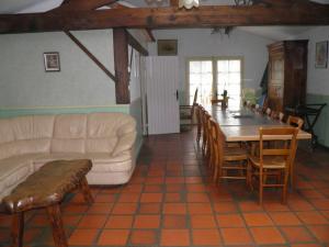 a living room with a couch and a table and chairs at Gîte Foussais-Payré, 7 pièces, 12 personnes - FR-1-426-121 in Payré-sur-Vendée